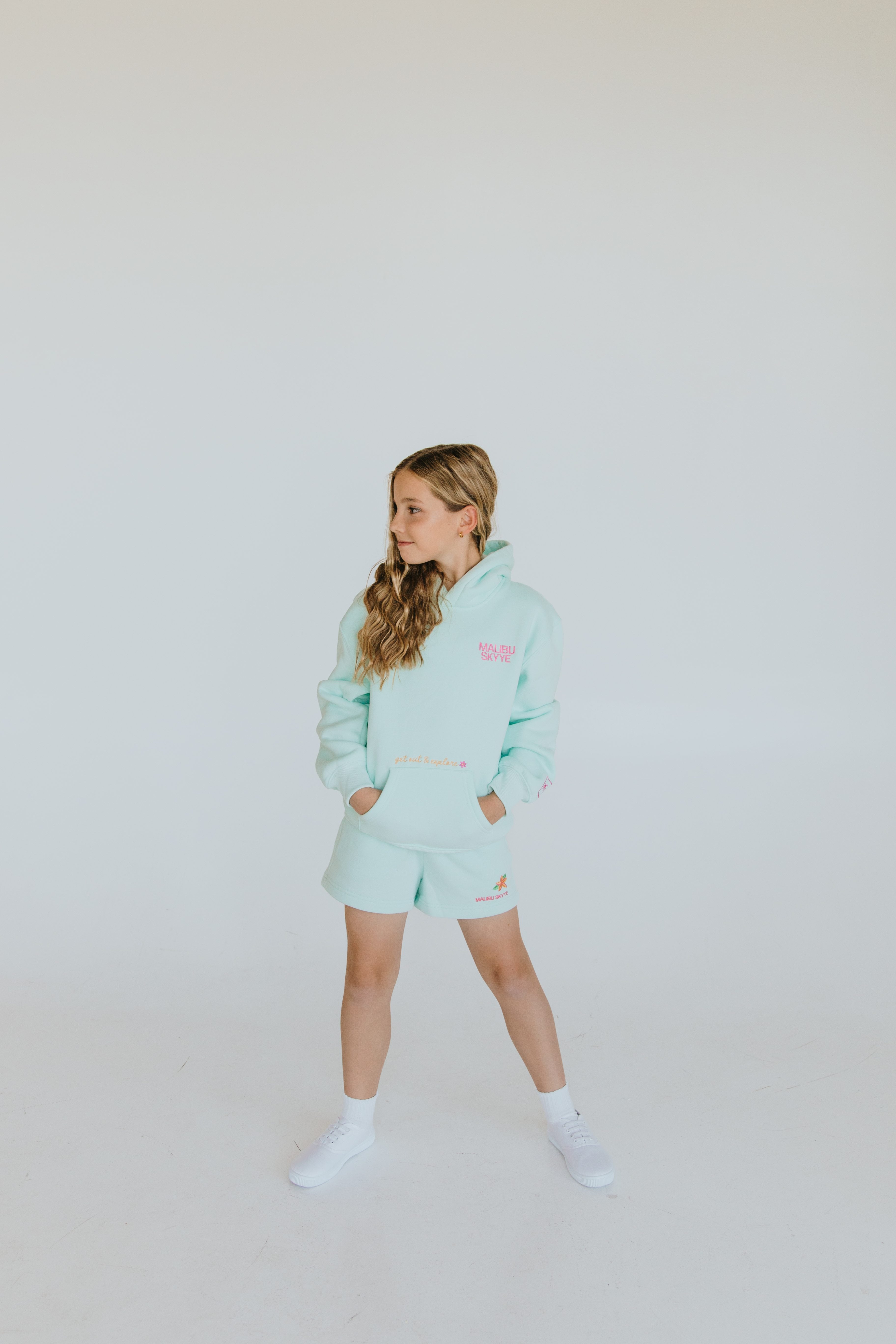 Young model in a mint sweatshirt photographed for a product lifestyle campaign
